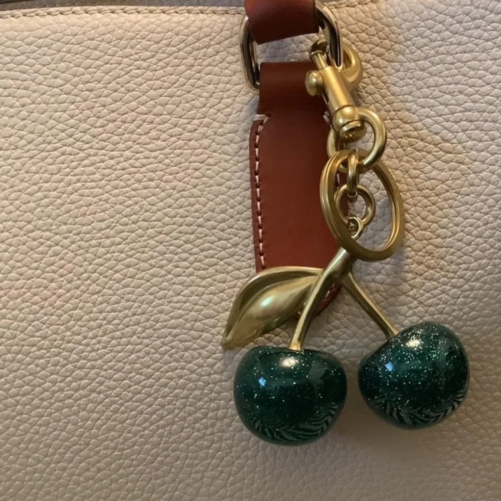 Cherry bag charm in hunter green with sparkles and gold hardware